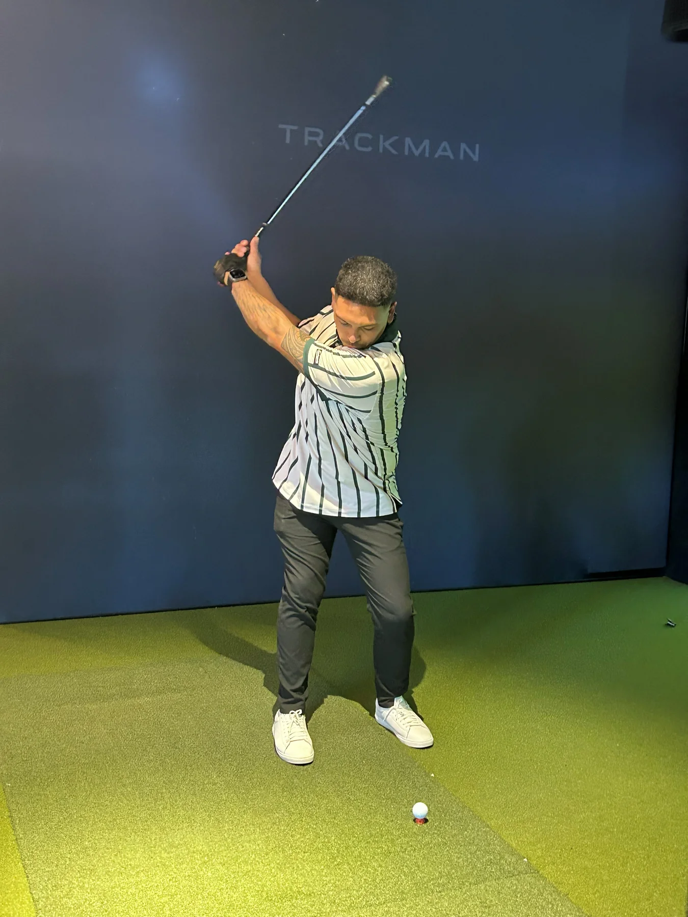 Guest swinging in the launch-party simulator bay.