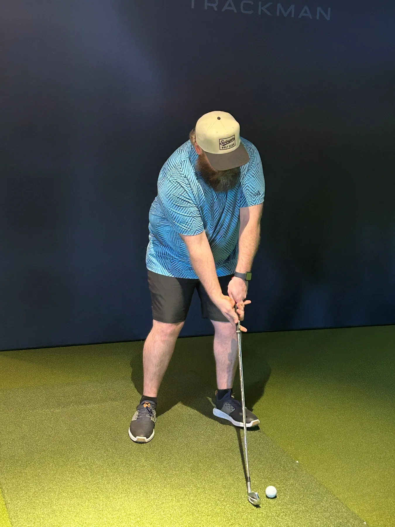 Guest wearing a Swingers Club hat in the simulator bay.